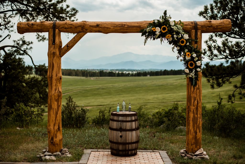 Ceremony arch at Younger Ranch with Pikes Peak in the distance
